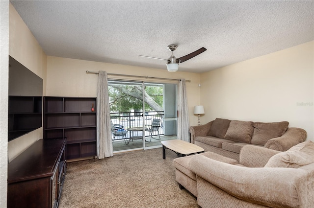 living room with carpet flooring, a textured ceiling, and ceiling fan