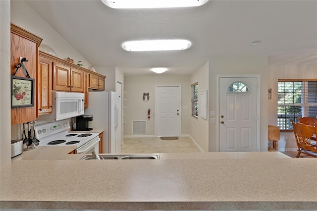 kitchen featuring light tile patterned flooring, white appliances, and lofted ceiling