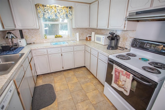 kitchen with white cabinetry, white appliances, sink, and backsplash