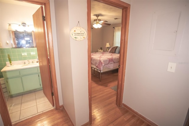 hall with sink and light hardwood / wood-style flooring