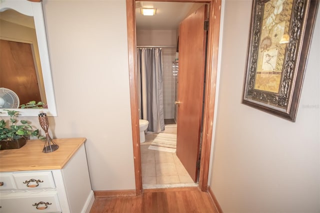 hallway with light hardwood / wood-style flooring