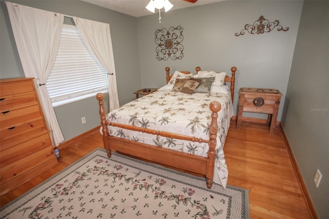 bedroom with hardwood / wood-style flooring and ceiling fan