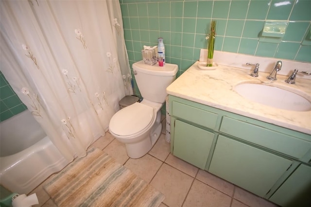 full bathroom featuring tile patterned floors, toilet, tile walls, vanity, and shower / bath combination with curtain