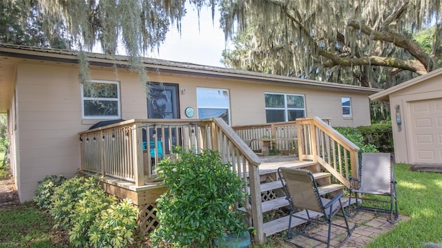 rear view of house featuring a wooden deck