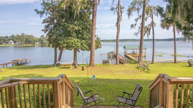 view of yard featuring a water view and a boat dock