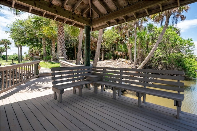 wooden deck featuring a water view