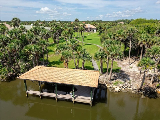 view of dock featuring a lawn, a water view, and boat lift