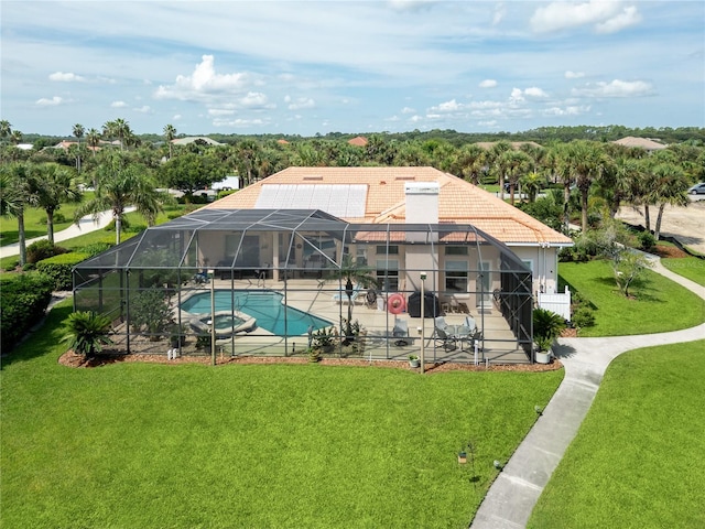 view of swimming pool featuring a yard, a lanai, a patio area, and an in ground hot tub