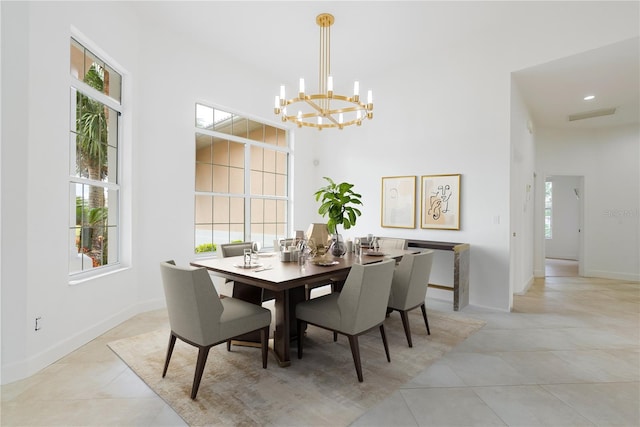 dining space with light tile patterned floors and an inviting chandelier