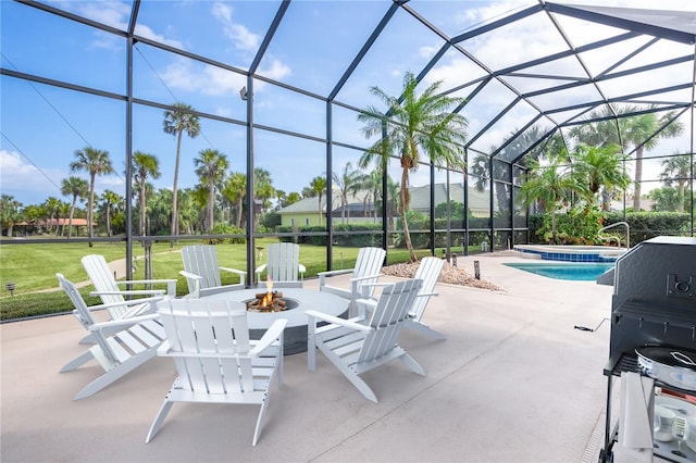 view of patio / terrace featuring a grill, glass enclosure, and a fire pit