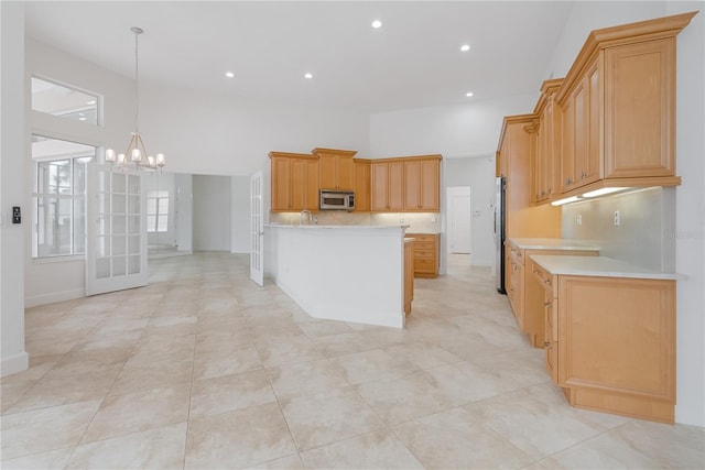 kitchen with pendant lighting, sink, an inviting chandelier, and appliances with stainless steel finishes