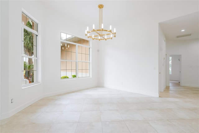 unfurnished dining area with light tile patterned floors and a notable chandelier