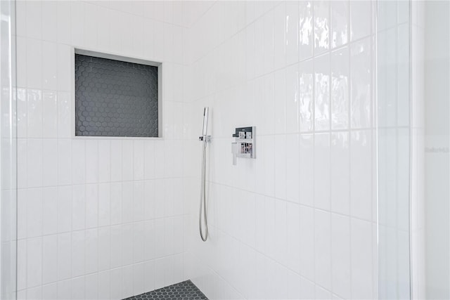 bathroom with a tile shower