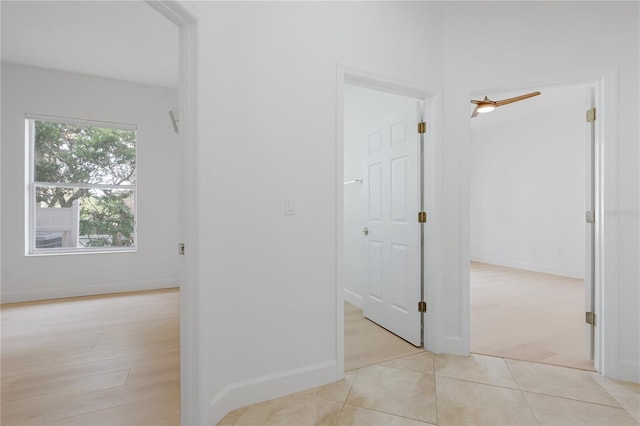 corridor featuring light tile patterned floors