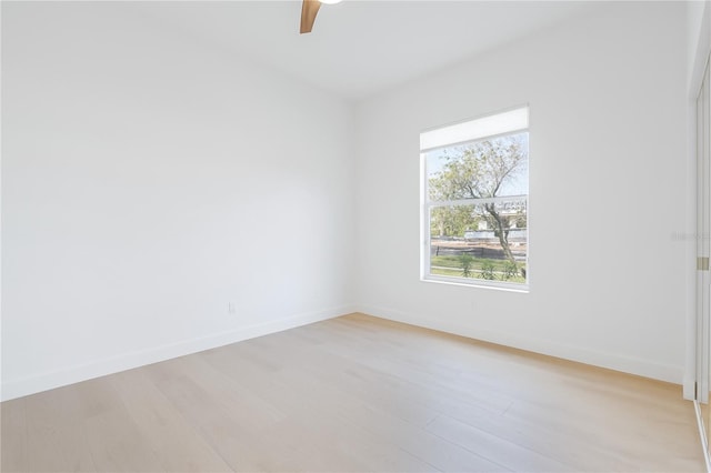 spare room featuring ceiling fan and light hardwood / wood-style flooring