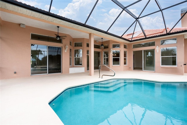 view of pool with ceiling fan, a lanai, and a patio