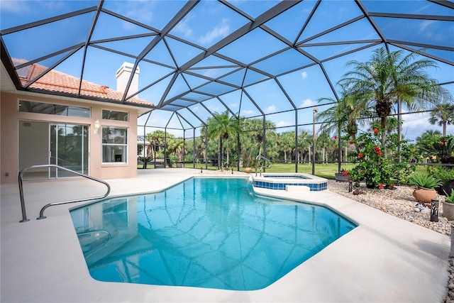 view of swimming pool with a patio, a pool with connected hot tub, and a lanai