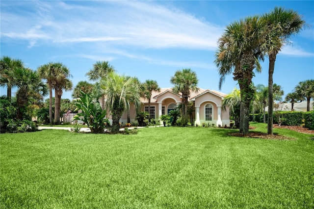 exterior space featuring stucco siding and a front lawn