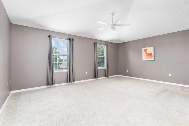 empty room featuring ceiling fan and carpet floors