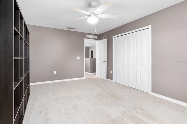 unfurnished bedroom with carpet flooring, a closet, and ceiling fan