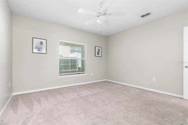 carpeted spare room featuring ceiling fan