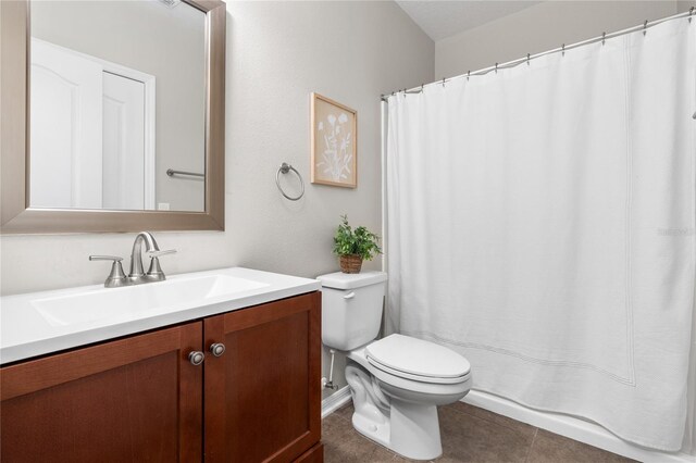 bathroom featuring toilet, tile patterned floors, and vanity