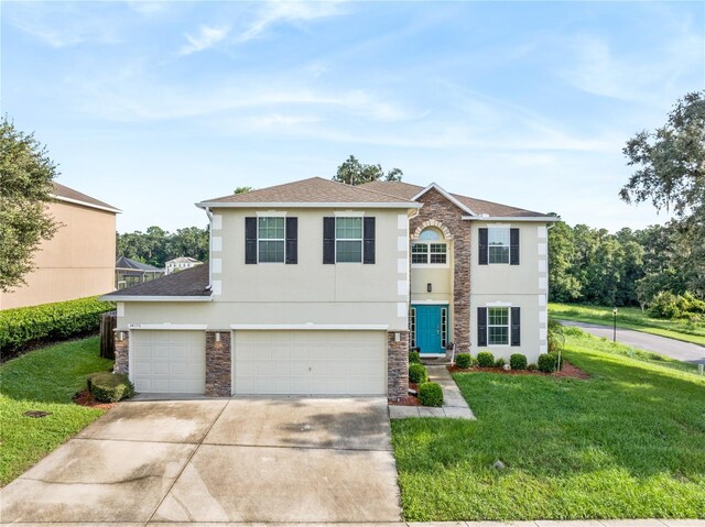 view of front of house featuring a garage and a front lawn