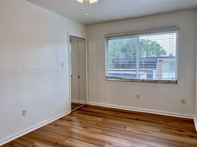 empty room with baseboards and wood finished floors