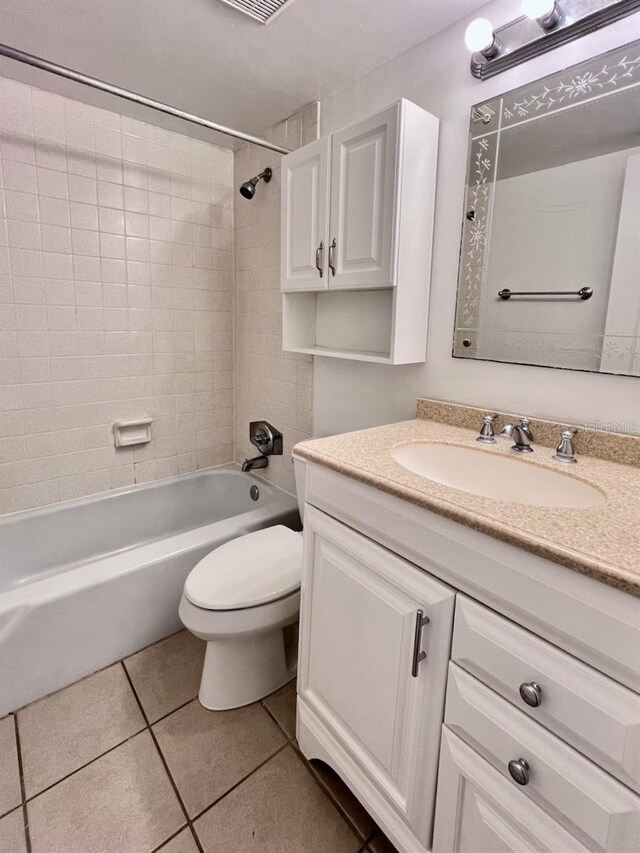 full bath with bathing tub / shower combination, vanity, toilet, and tile patterned floors