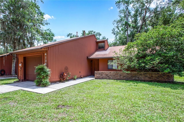 view of front of home with a front yard and a garage