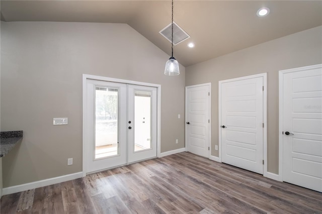 interior space featuring lofted ceiling, french doors, and wood-type flooring