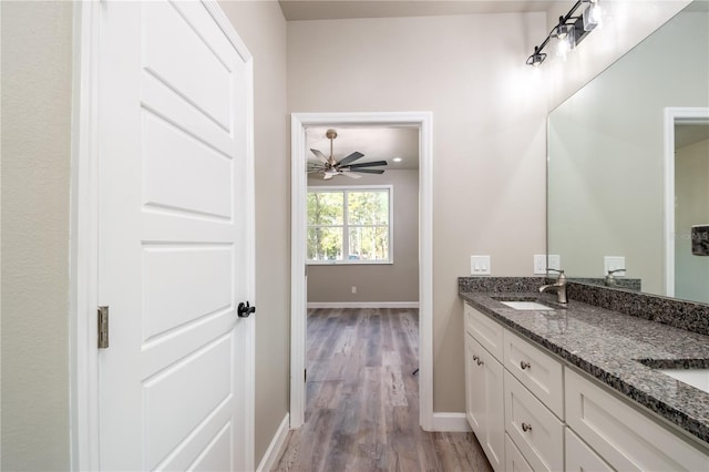 bathroom with ceiling fan, wood-type flooring, and vanity