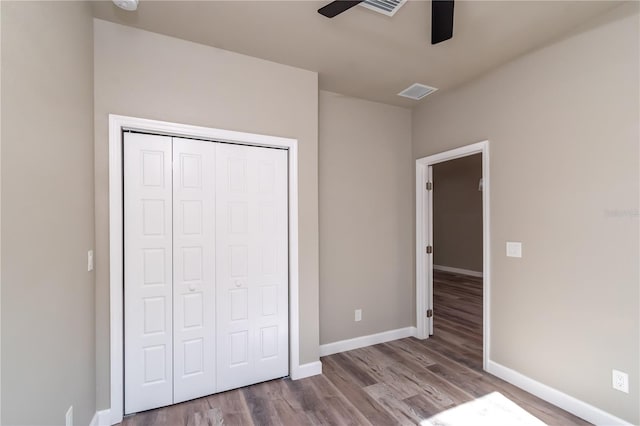 unfurnished bedroom featuring a closet, ceiling fan, and light hardwood / wood-style flooring