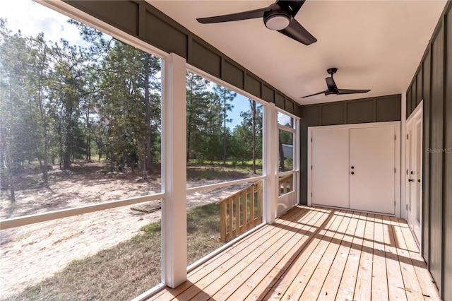 unfurnished sunroom with ceiling fan