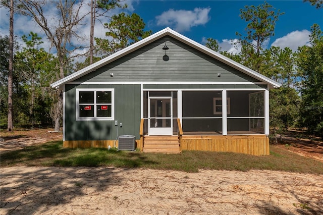 rear view of property with a sunroom