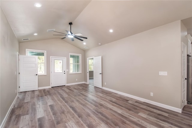 empty room featuring lofted ceiling, hardwood / wood-style flooring, and ceiling fan