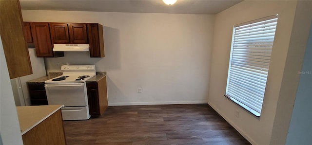 kitchen with electric stove, light countertops, dark wood-type flooring, under cabinet range hood, and baseboards