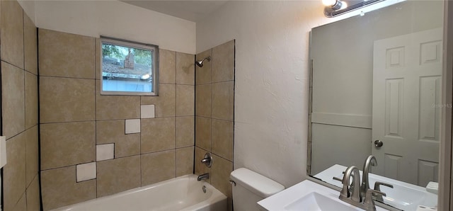 bathroom with a sink, shower / bathing tub combination, and toilet