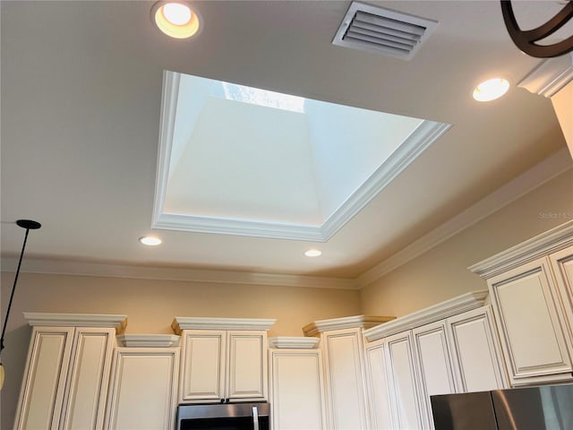 room details with cream cabinets, recessed lighting, visible vents, ornamental molding, and pendant lighting