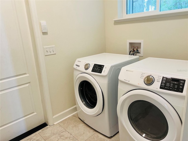 laundry area with laundry area, light tile patterned floors, baseboards, and separate washer and dryer