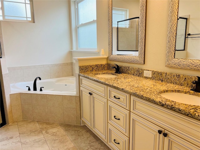 bathroom featuring double vanity, a garden tub, a sink, and tiled shower