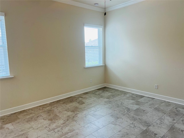 spare room with crown molding and baseboards