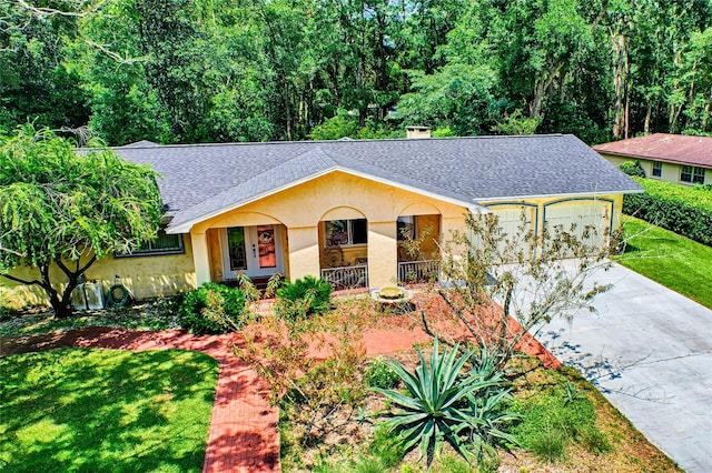 single story home featuring a front lawn, a garage, and covered porch