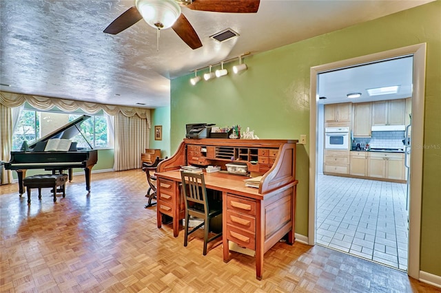 interior space featuring ceiling fan and light parquet flooring