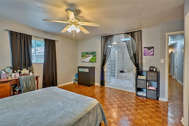 bedroom featuring parquet floors, ensuite bath, and ceiling fan