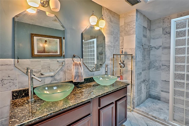 bathroom featuring tile walls, vanity, and tiled shower