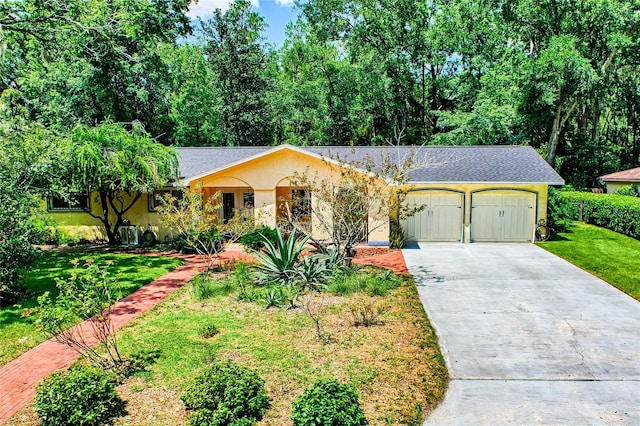 single story home with a front yard and a garage