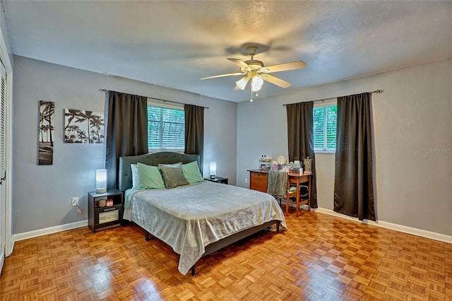 bedroom with ceiling fan and light parquet flooring