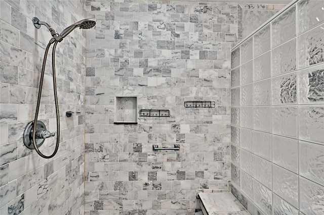 bathroom featuring a tile shower