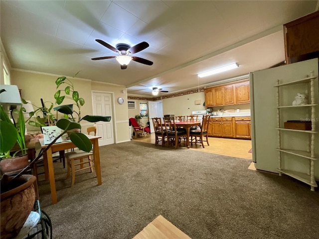 recreation room with ceiling fan, ornamental molding, and light carpet